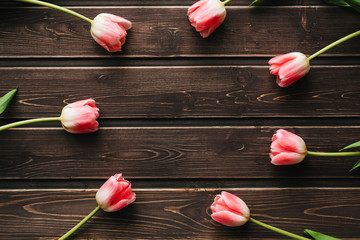 pink flowers tulips on wooden table for greeting card template