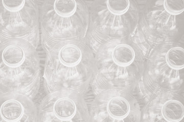 Top down view of empty water bottles; plastic water bottles neatly arranged in rows