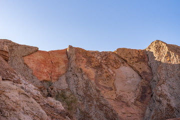Low angle landscape of barren stone hillsides at Mecca Wilderness in Southern California