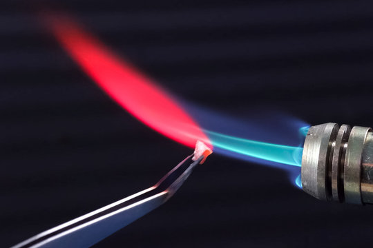 Heating the gas torch pieces of metal.