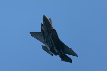 Fototapeta na wymiar Bottom view of an F-35 Lightning II approaching in beautiful light