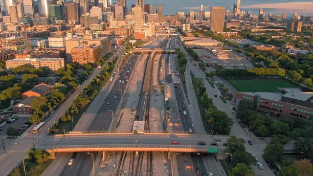 Aerial: The Chicago city skyline & traffic on the 290 Freeway at sunset. Illinois, USA.