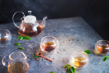 Morning teatime header, cozy glass tea set with leaves and steam