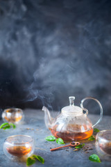 Morning light tea scene, stone table, double wall glass bowls, and a teapot