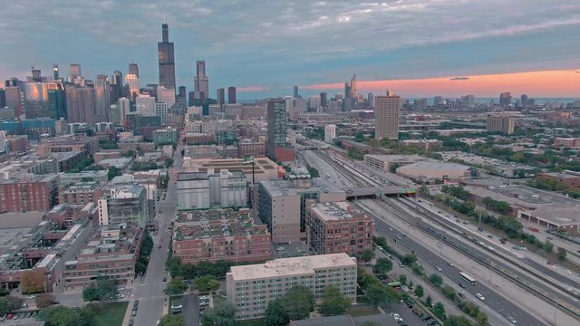 Aerial: The Chicago city skyline & traffic on the 290 Freeway at sunset. Illinois, USA.