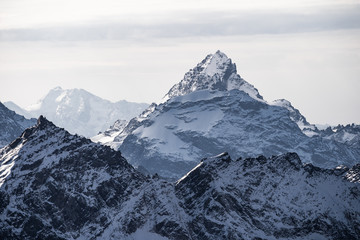 Fototapeta na wymiar Majestic mountain peak covered in snow. Caucasian ridge