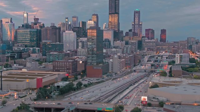 Aerial: The Chicago city skyline & traffic on the 290 Freeway at sunset. Illinois, USA.
