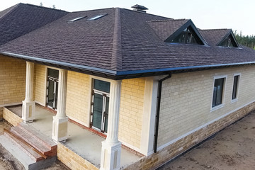 Bituminous tile for a roof. House with a roof from a bituminous
