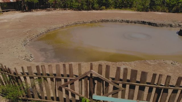 Closeup of L'eau Michel mud volcano bubbling from the center of the cone in Bunsee Trace penal, Trinidad and Tobago