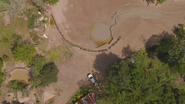 Descending aerial of a wet type mud volcano located in bunsee trace penal, Trinidad and Tobago