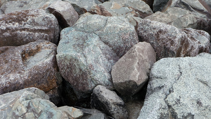 Background of large rough boulders in gray and brown.