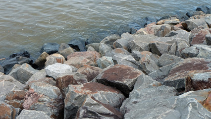 Seaside coastal area with large rocks.