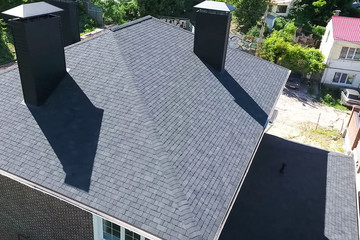 Bituminous tile for a roof. House with a roof from a bituminous