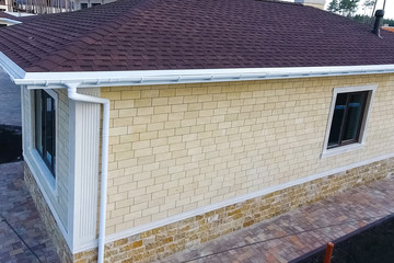 Bituminous tile for a roof. House with a roof from a bituminous