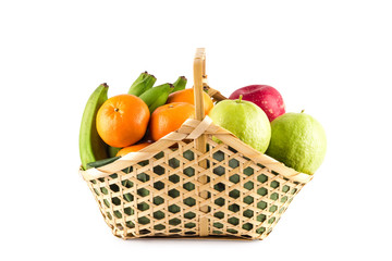 orange, guava, banana and apple in wicker basket on white background fruit health food isolated