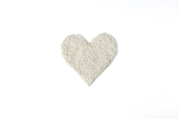 Pile of rice seed in heart shape isolated on white background