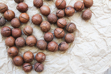 Organic macadamia nuts on baking paper background 