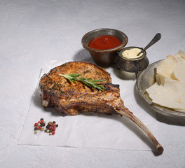 Tomahawk pork steak  on a gray background