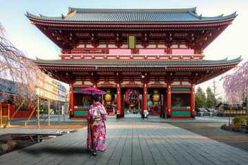 Young asian woman wearing Kimono Japanese tradition dressed sightseeing at Sensoji temple gate with...