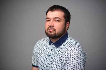 Arrogant portrait of a bearded man.