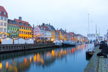 Fototapeta na wymiar Nyhavn embankment with old ships along the Nyhavn Canal in Copenhagen, Denmark