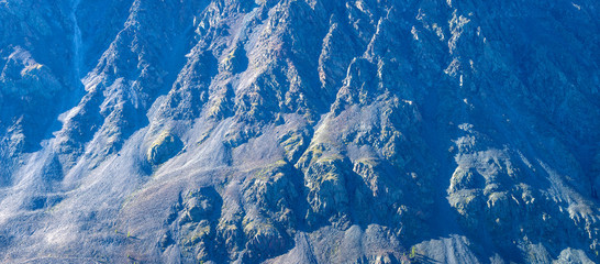 Panoramic view of a rocky hillside, contrast of light and shadow