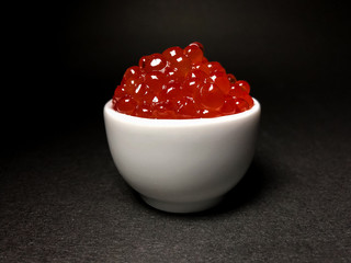 Red salmon caviar. Delicacy. Close-up on an isolated background.