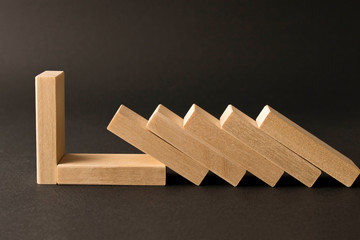 Playing dominoes on a dark background. Leisure games concept. Domino effect. Selective focus.