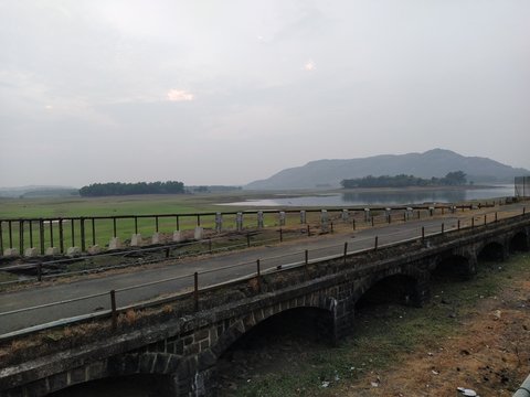 An old bridge over the meadow with almost zero traffic. Spending an evening at the countryside.