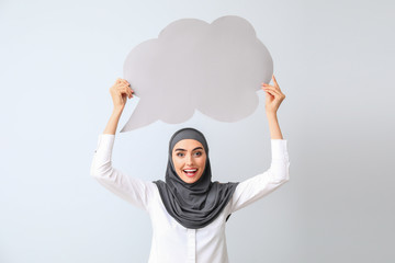 Beautiful Arab woman with blank speech bubble on light background