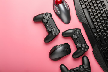 Modern gaming accessories on color background
