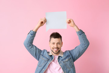 Man with blank speech bubble on color background