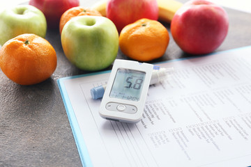 Laboratory test, glucometer, fruits and lancet pen on table. Diabetes concept