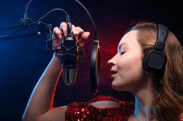 Girl sings into a microphone. Screensaver for a vocal school, work and training in vocals. Singing and lesson in music. Bright background.