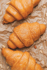 Tasty fresh croissants on table