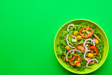 Plate with tasty salad on color background