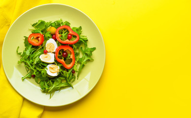 Plate with tasty salad on color background