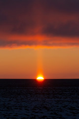 Winter frosty sunrise in the open area above the snowy surface of agricultural fields.