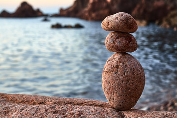 Fototapeta na wymiar Three stones in balanced by the sea