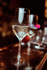 white wine in a glass against a bar