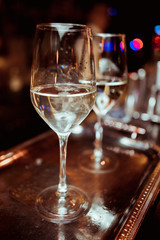 white wine in a glass against a bar