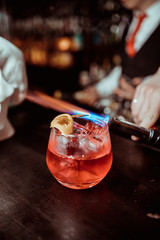 Pink and red Fresh colorful exotic alcoholic cocktail with lemon and ice in the bar. Colorful pink Soft drink with ice on the bar desk. Red colorful Mojito