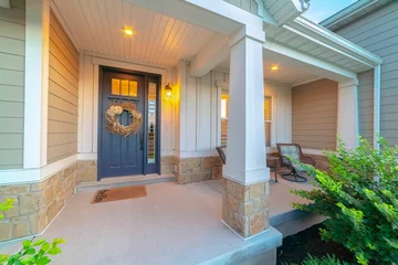 Fotobehang Front and sidelight of home with front porch and wood siding exetrior wall © Jason