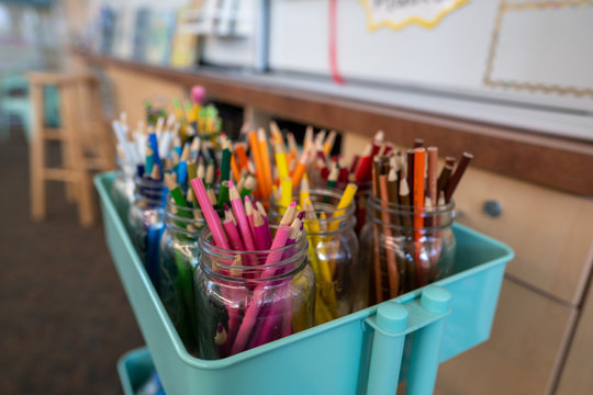 Cart filled with jars of color pencils for artwork in classroom