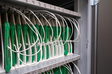 Row of tablets in protective cases being charged in a cabinet in enterprise office location