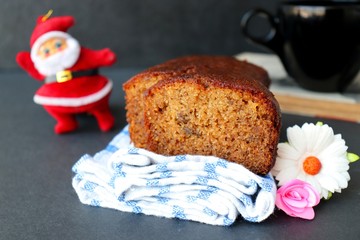 Homemade banana bread and slice on a table close-up. Christmas concept. Christmas cake with holiday background