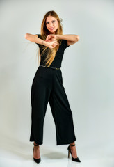 Model student manager stands in different poses in front of the camera in the studio. Full-length...