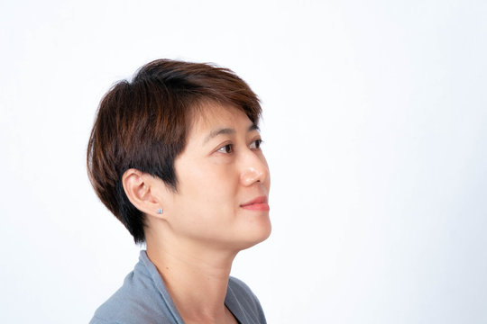 Portrait of short-haired Asian woman smiling side-facing On a white background