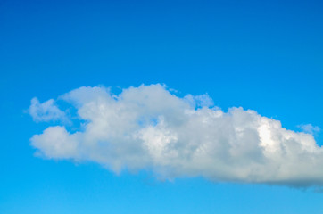 White fluffy cumulus cloud. Blue sky. Close-up