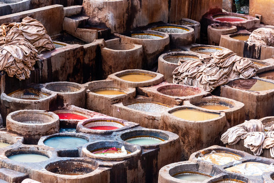 Dye reservoirs and vats in traditional tannery of city of Fez, Morocco.